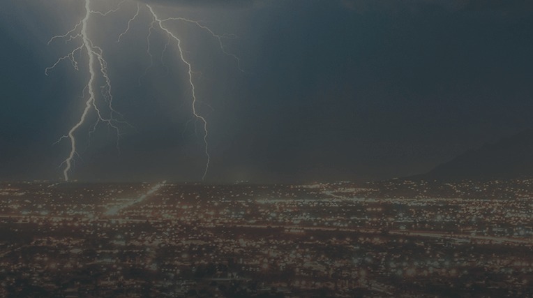 Large lightening strike over a city at night